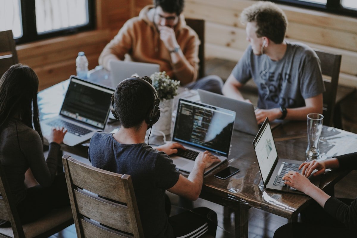 A small marketing team reviewing work together at a desk